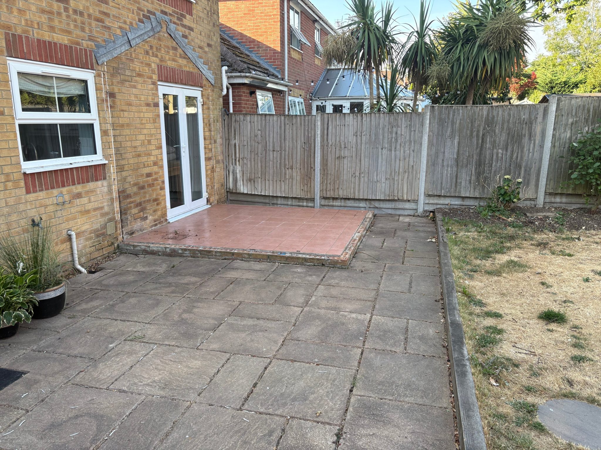Before: the raised pink quarry tile platform outside the French doors, sitting on top of the old slab patio.