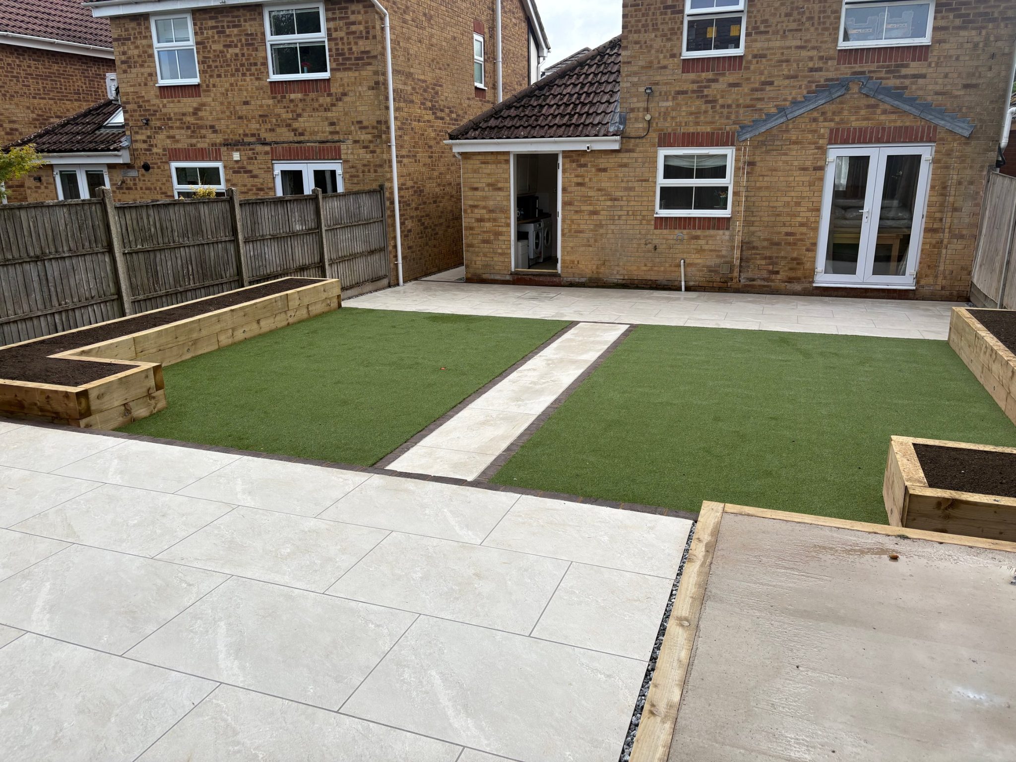 Looking back towards the house from the sleeper shed base in the top-left corner, over the upper patio, lawns and terrace.