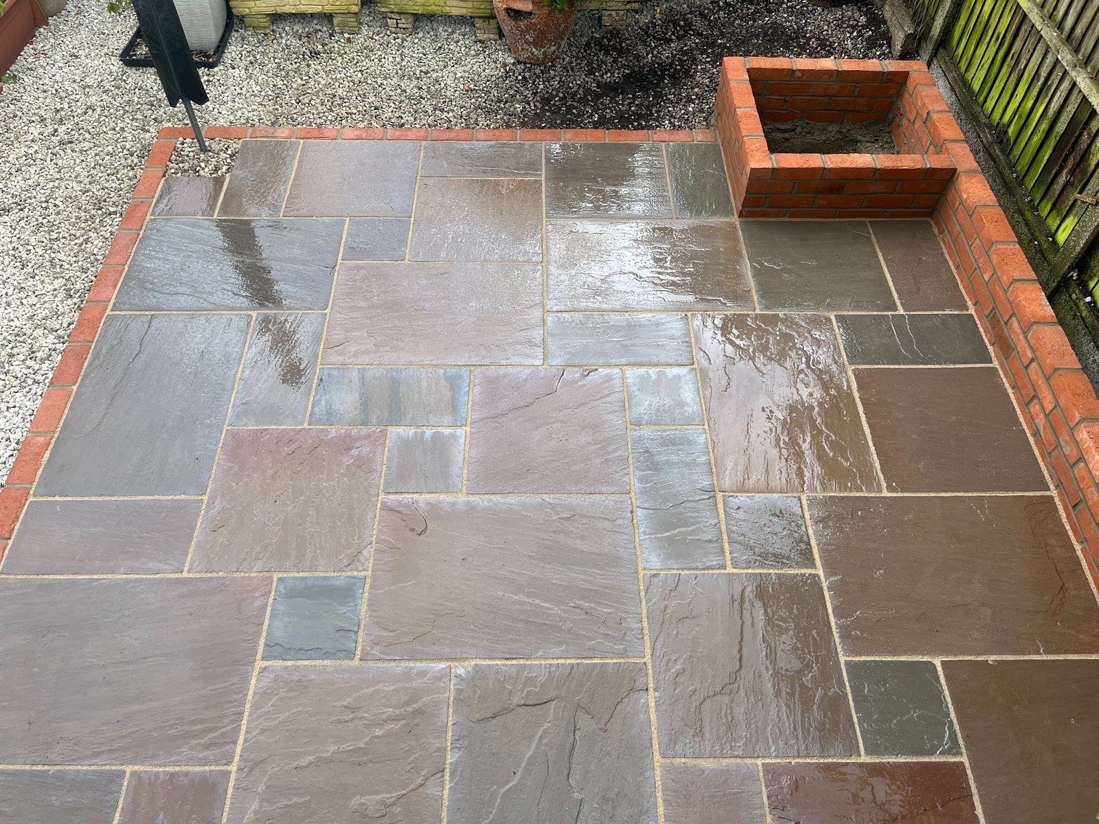 After rain &mdash; the sandstone tones come alive with moisture, showing the variation in slab colour the random course delivers.