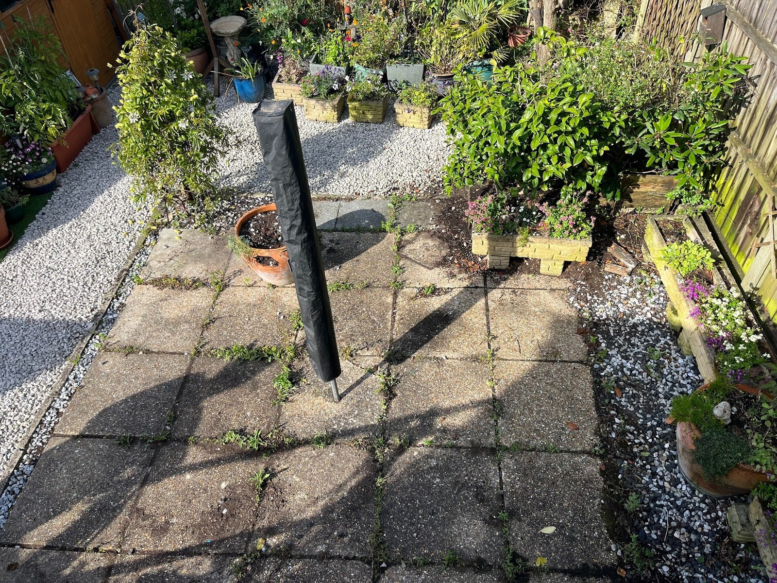 Pre-build view of the original concrete patio &mdash; lifting at the edges, joints failing, the whole zone tired and unloved.