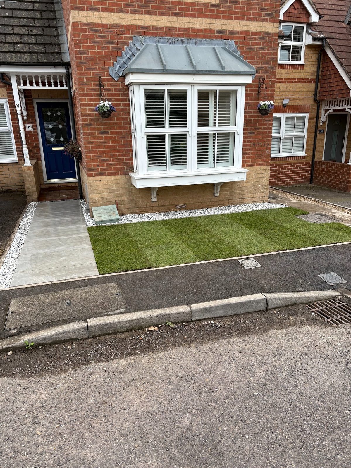 The finished front garden in Fareham: a new porcelain pathway to the door, a fresh lawn, and a white gravel border under the bay window.