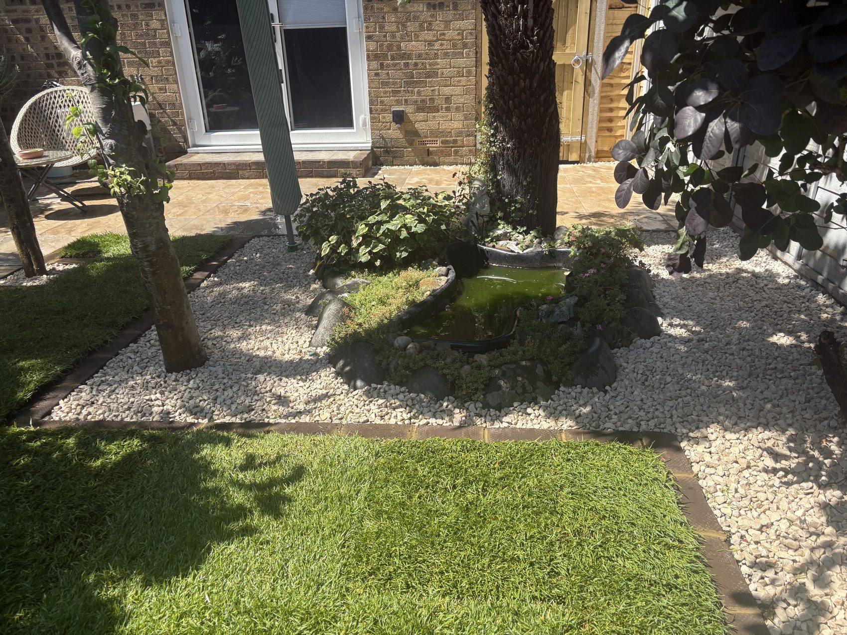 The new garden gate and section of fencing, framed by concrete gate posts.