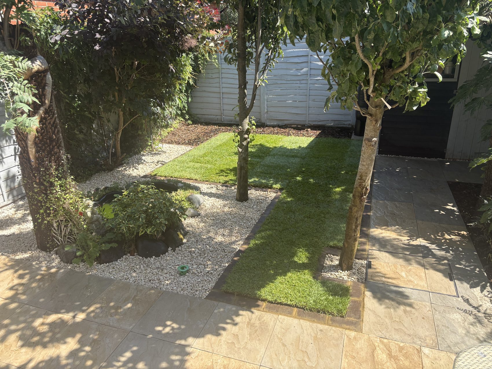 Detail of the existing pond, kept and tidied within the new brick-edged planting bed.