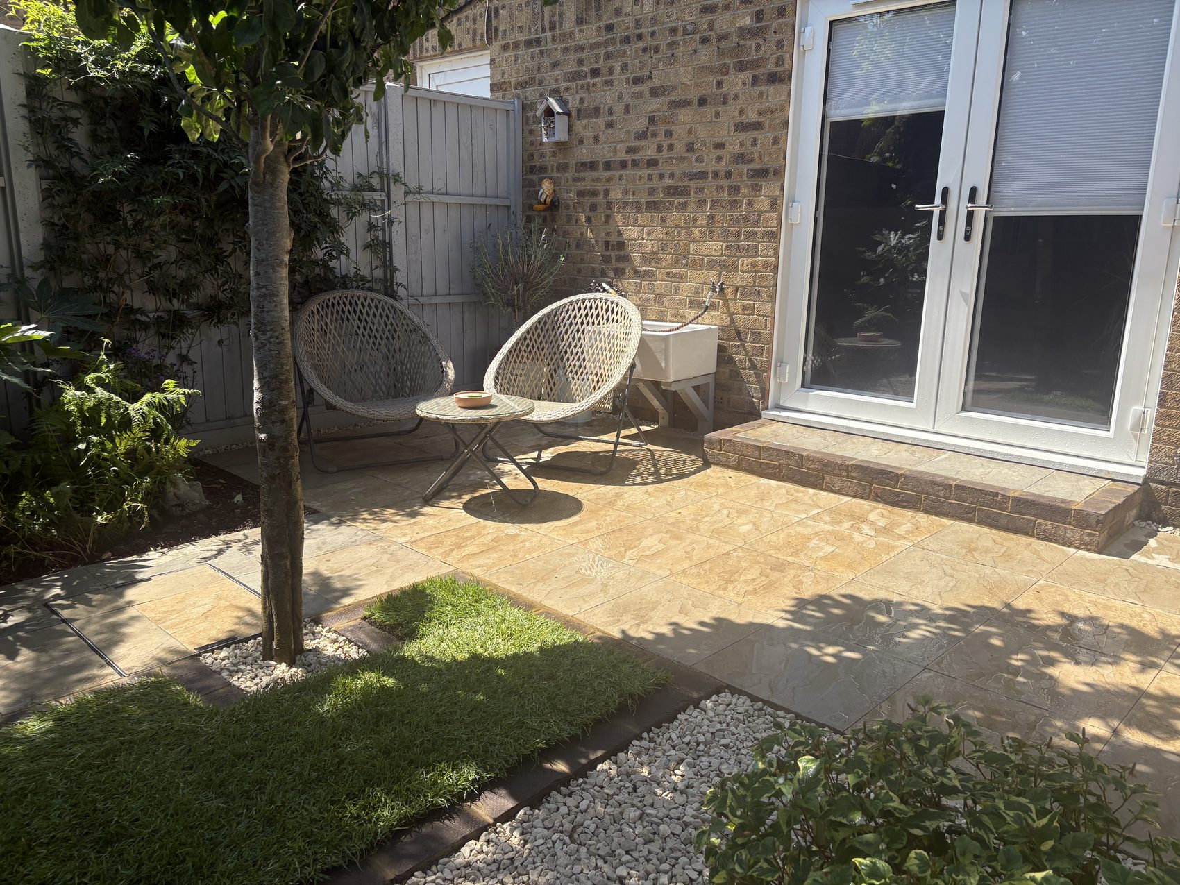 The finished Locks Heath garden: new lawn edged in brick, planting beds and the existing pond, with the new patio beyond