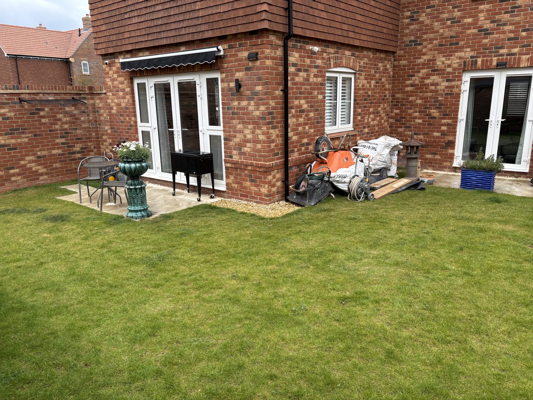 Before: the single narrow patio by the back door, barely wide enough for a table and chairs.