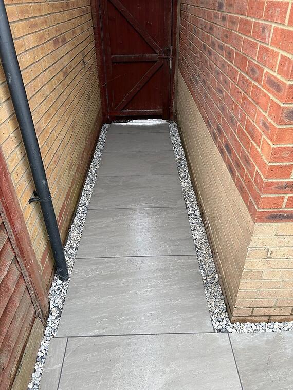 Full garden transformation, Fareham -- The side access path relaid in matching porcelain, edged in gravel for drainage.