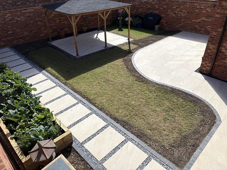 Curved patio, Warsash -- Overhead view of the finished garden: the curved porcelain terrace, gazebo patio and stepping-stone path.
